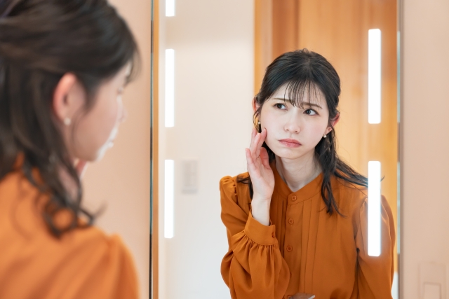鏡を見る女性の画像